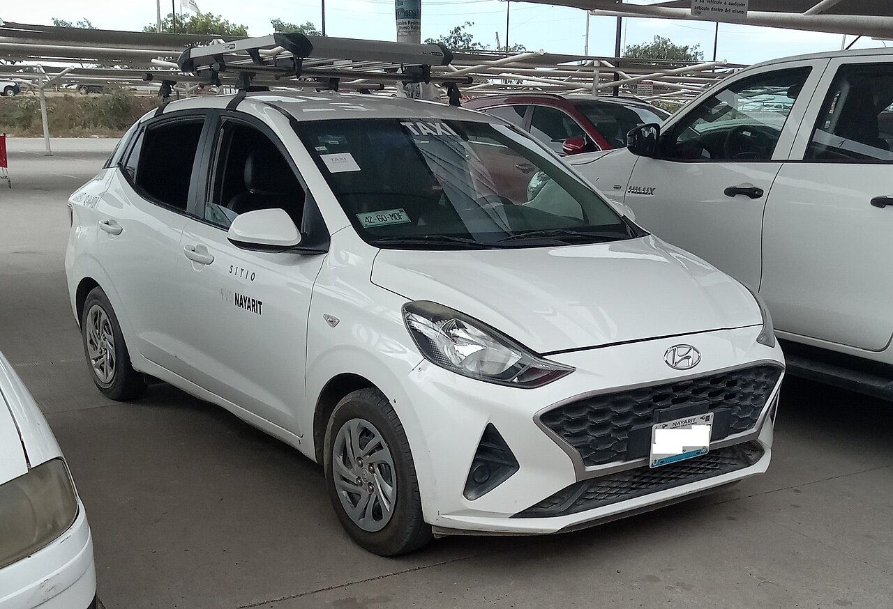 Hyundai Grand i10: Grand i10 hatchback blanco del diseño actual, con portaequipaje de techo, vista delantera de tres cuartos